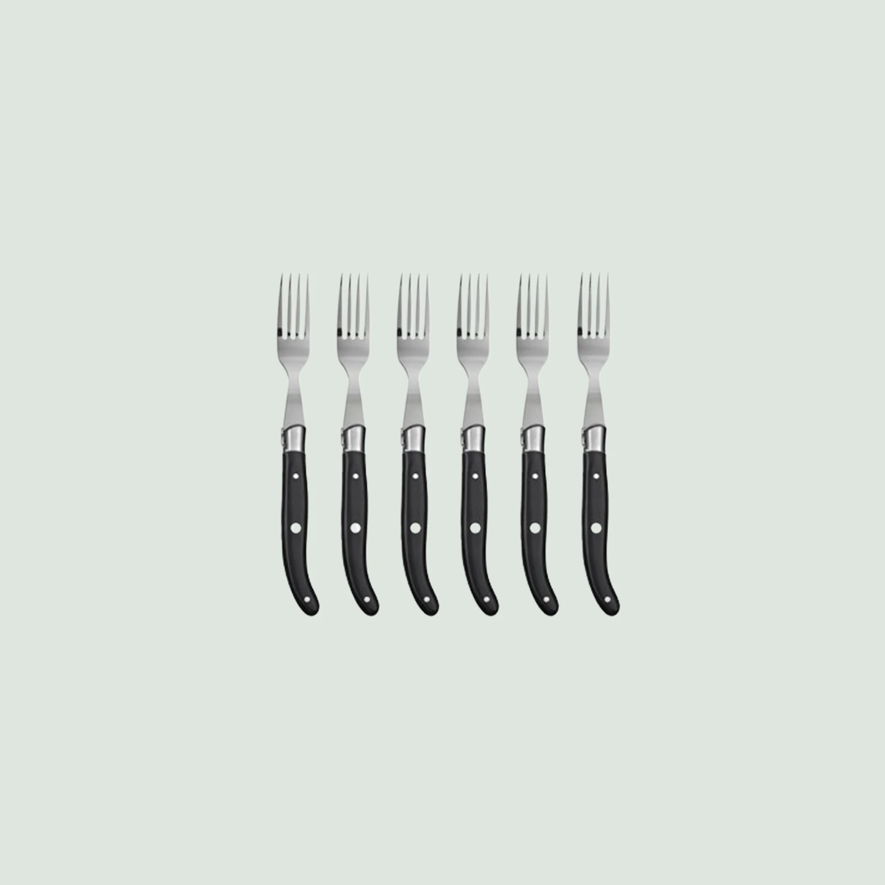 Close-up of Laguiole steak fork with wood handle and polished bolster