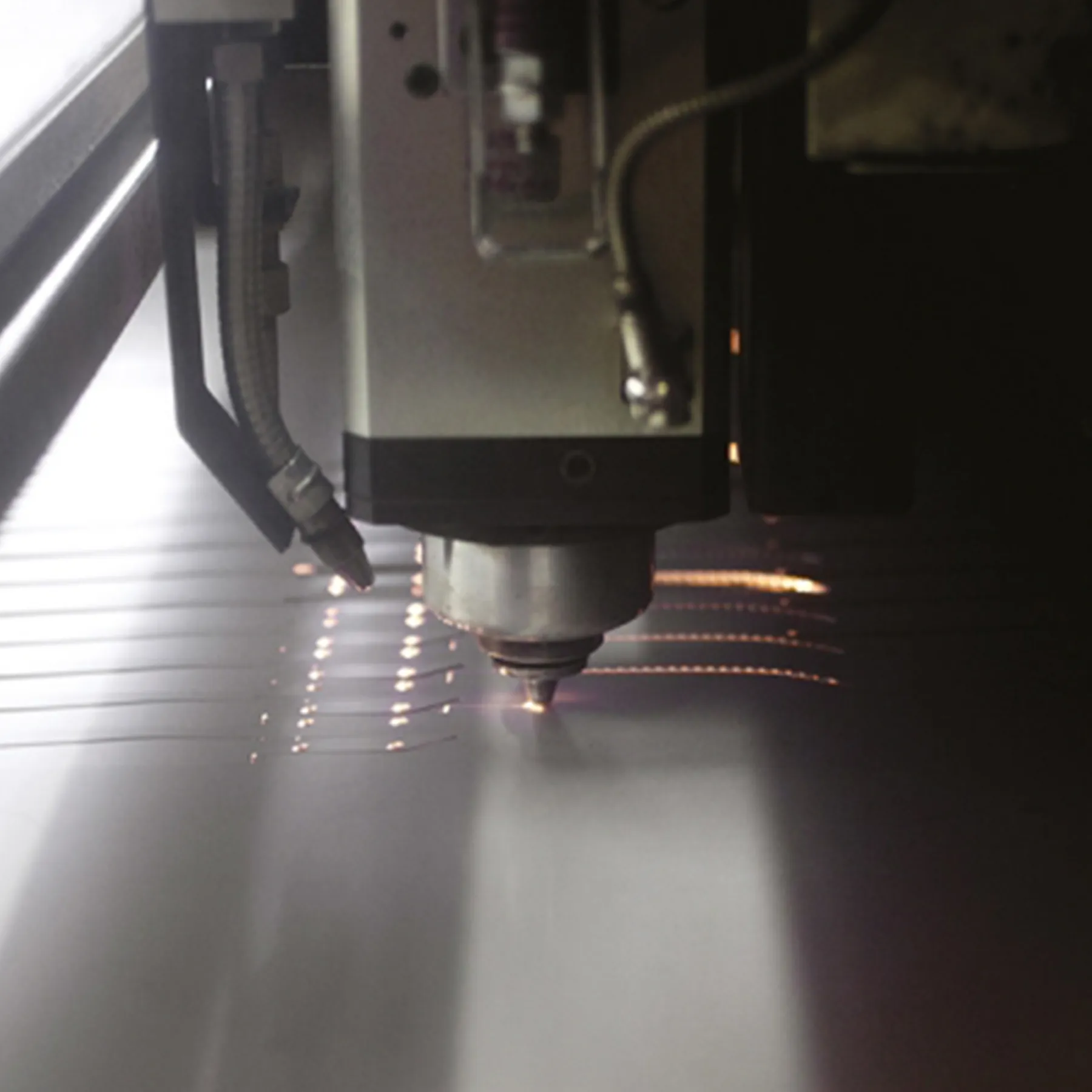 Laser engraving tool personalizing a bread knife handle at the Claude Dozorme workshop, combining tradition with modern techniques