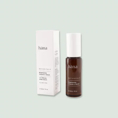 Close-up of Brightening Vitamin C Serum bottle next to its packaging, showcasing the label and product details.