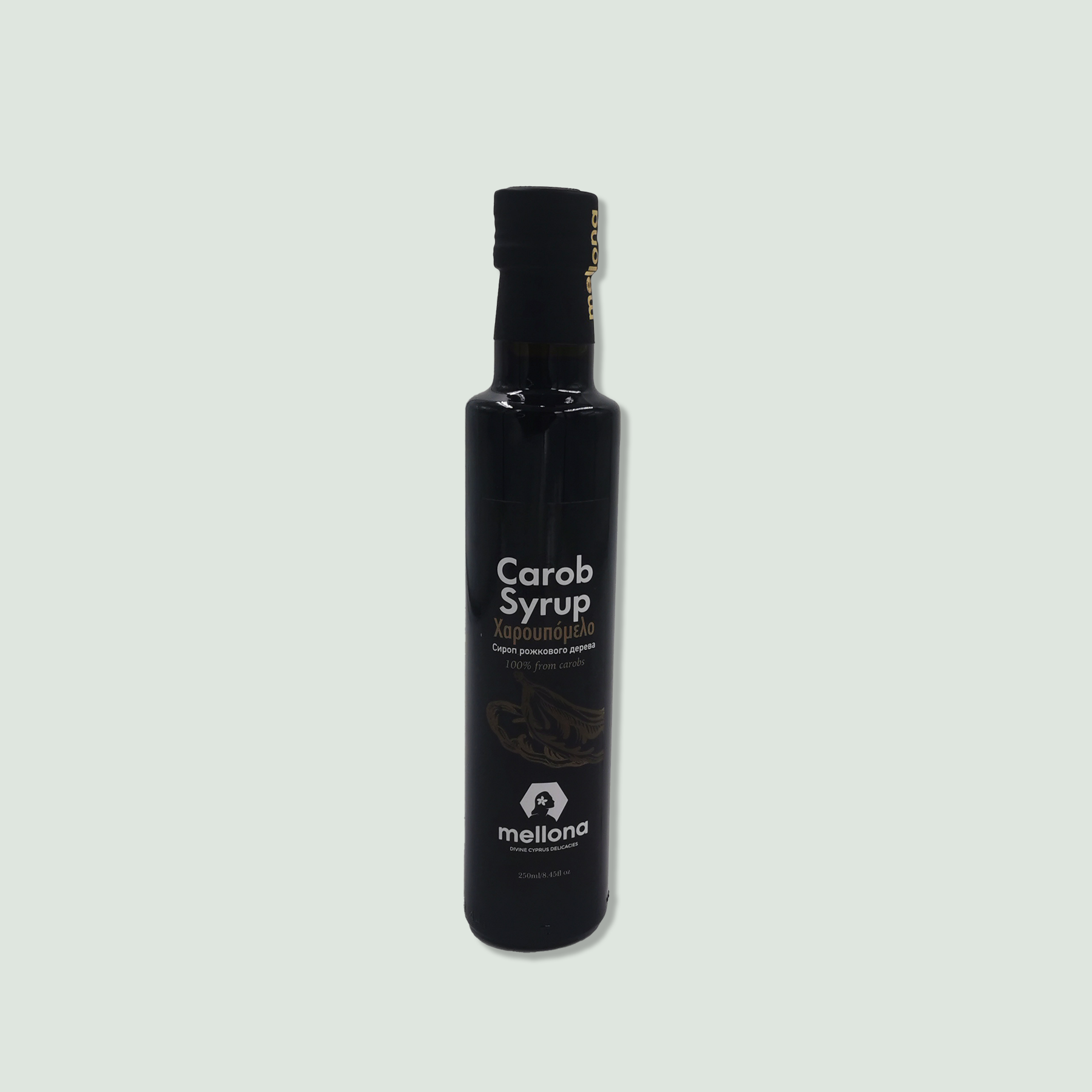 A black bottle of Mellona Carob Syrup with a black cap and label, displaying the product name in English and Greek, and a small logo at the bottom.