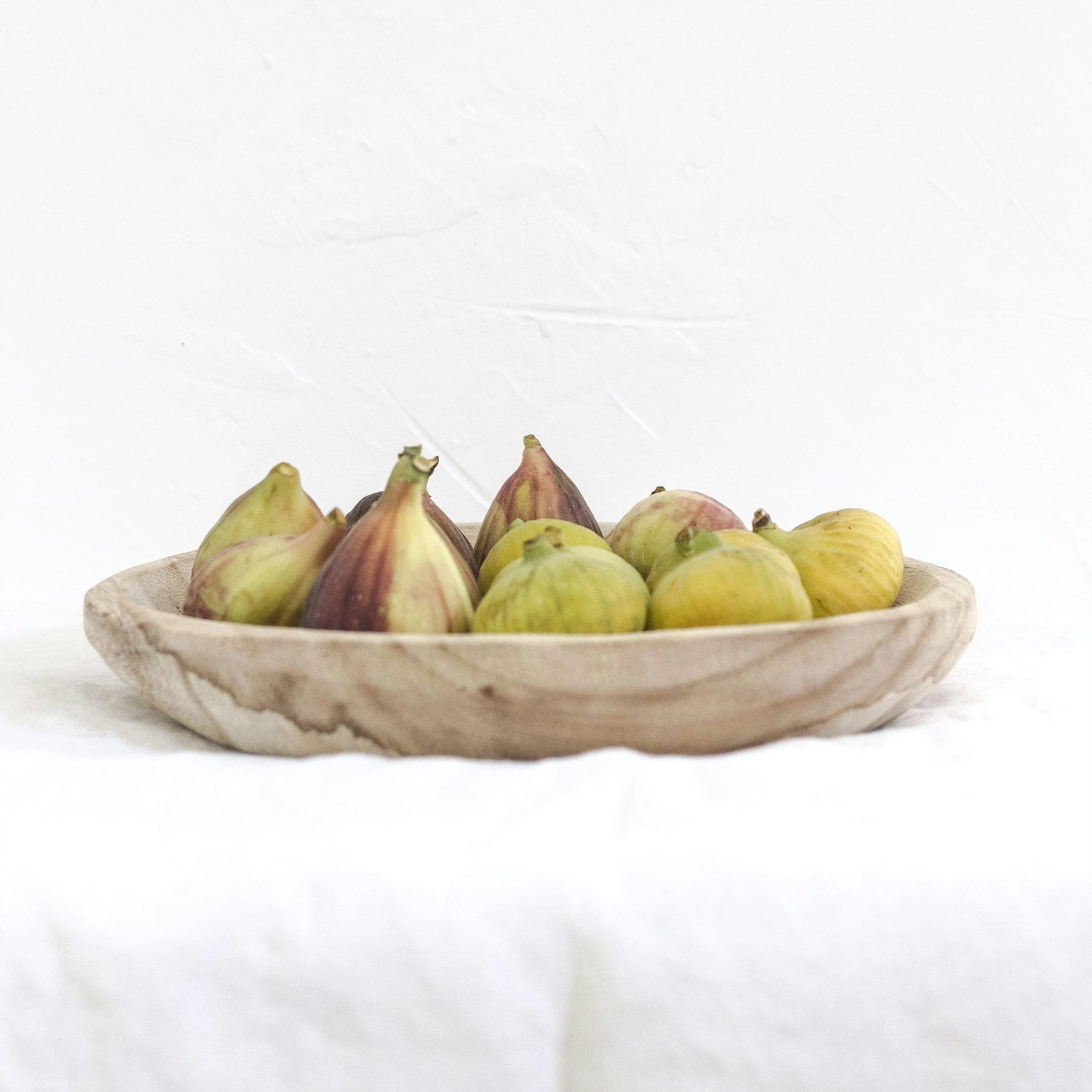 A plate of fresh figs, highlighting their vibrant colors and natural texture, perfect for pairing with fig jam.