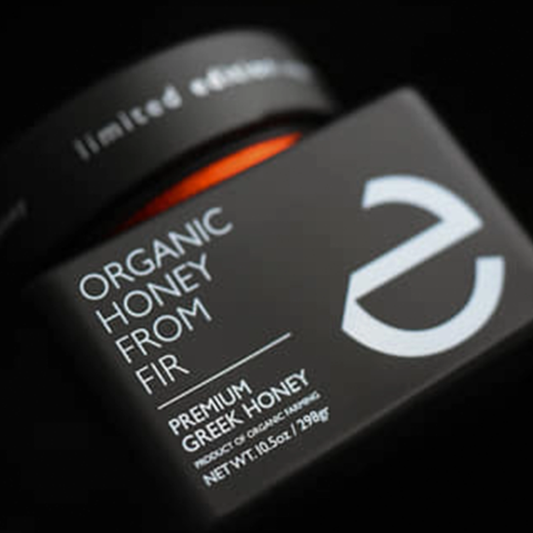 Artistic close-up of Eulogia’s Premium Organic Greek Honey bottle