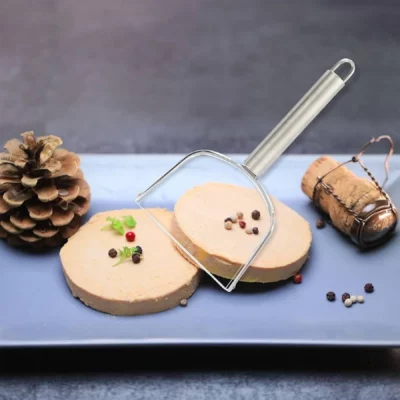 Wire foie gras cutter making clean slices on a block of foie gras