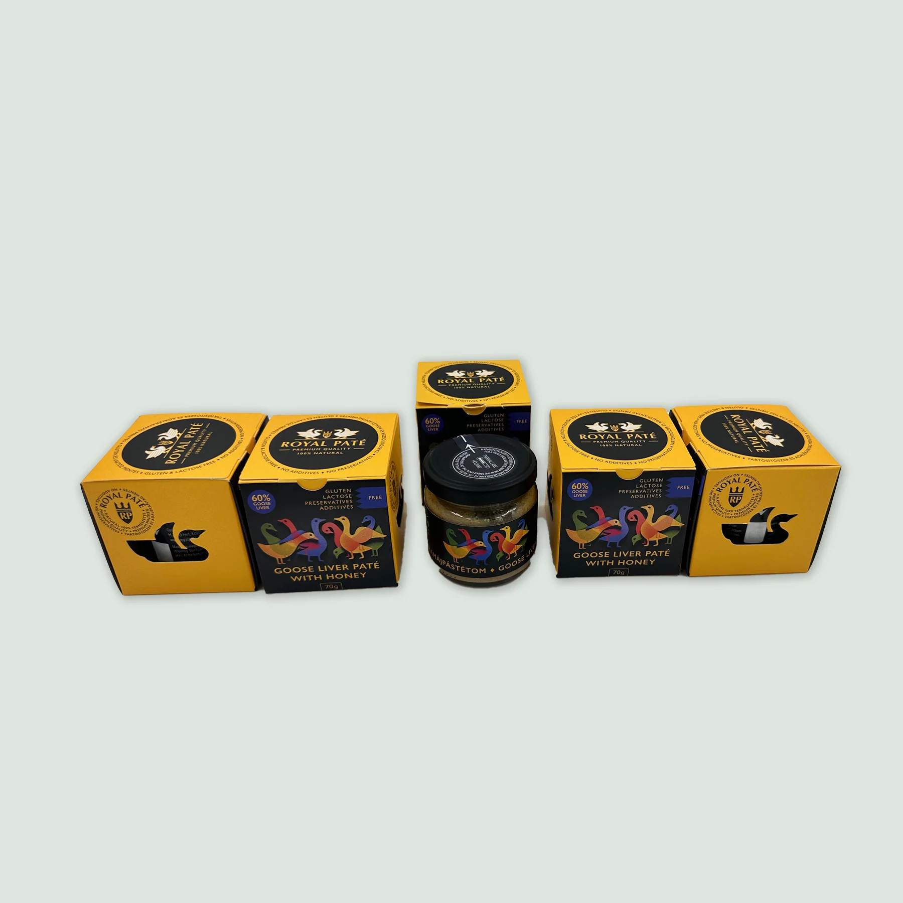 Five elegant jars of Royal Goose Liver Pate with Hungarian honey, lined up on a wooden surface, ideal for gifting or gourmet gatherings.
