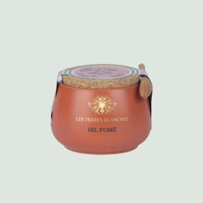 Ceramic jar of smoked salt with spoon