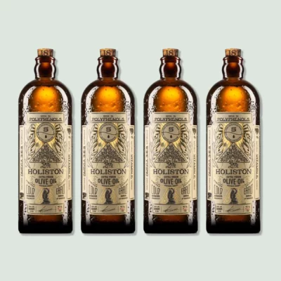 Four bottles of Holiston Best Olive Oil. The bottles are amber-colored with vintage-style labels indicating high polyphenol content, cold extraction, and early harvest. Each bottle has a capacity of 500ml.