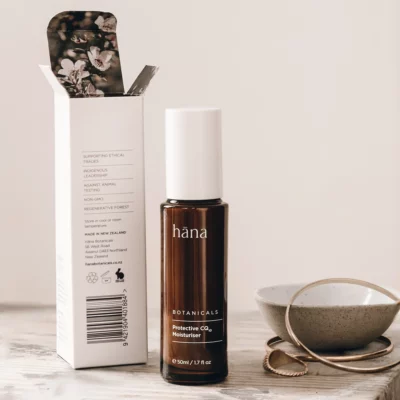 Close-up of Protective CQ10 Moisturiser bottle with its packaging, highlighting key ingredients like Coenzyme Q10 and Raspberry Seed Oil.