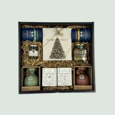 wooden box with mediterranean goodies - chocolates olive oil foies gras and olives as a christmas gift