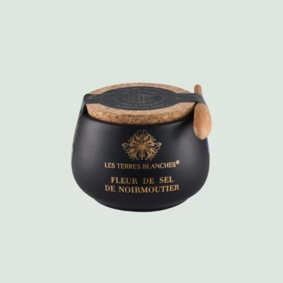 Fleur de sel de Noirmoutier salt in black ceramic jar with spoon – front view