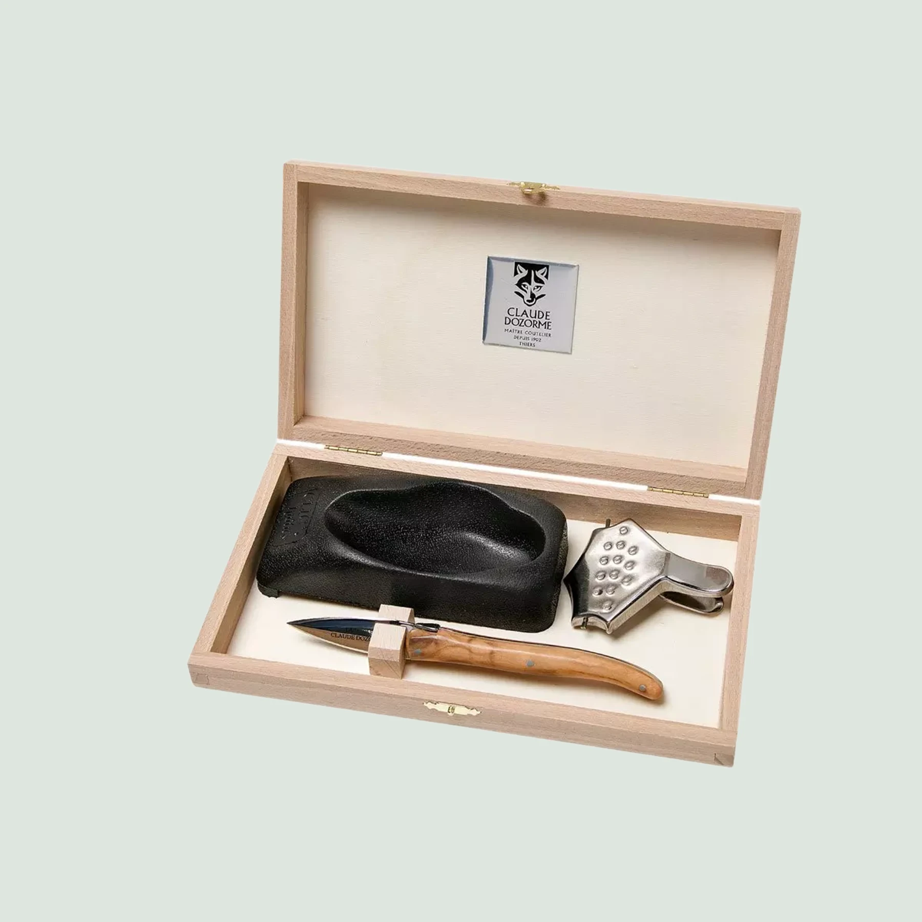 Complete oyster knife set with lemon squeezer, oyster holder, and wooden box by Claude Dozorme