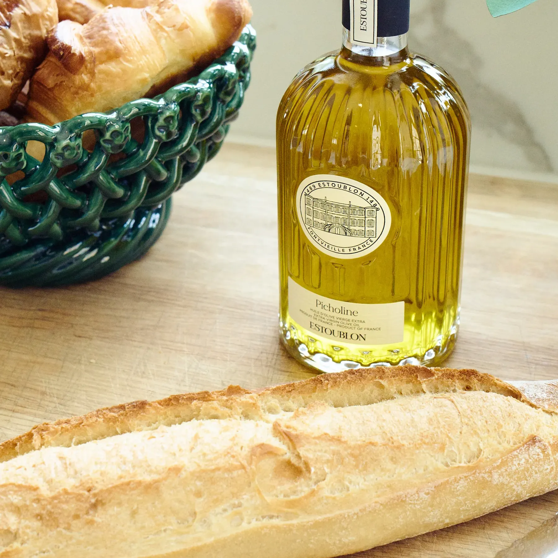 Close-up of premium French olive oil with green hue