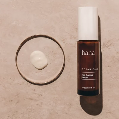 Close-up applying Pro-Aging Serum, showing the texture of the serum on the skin.