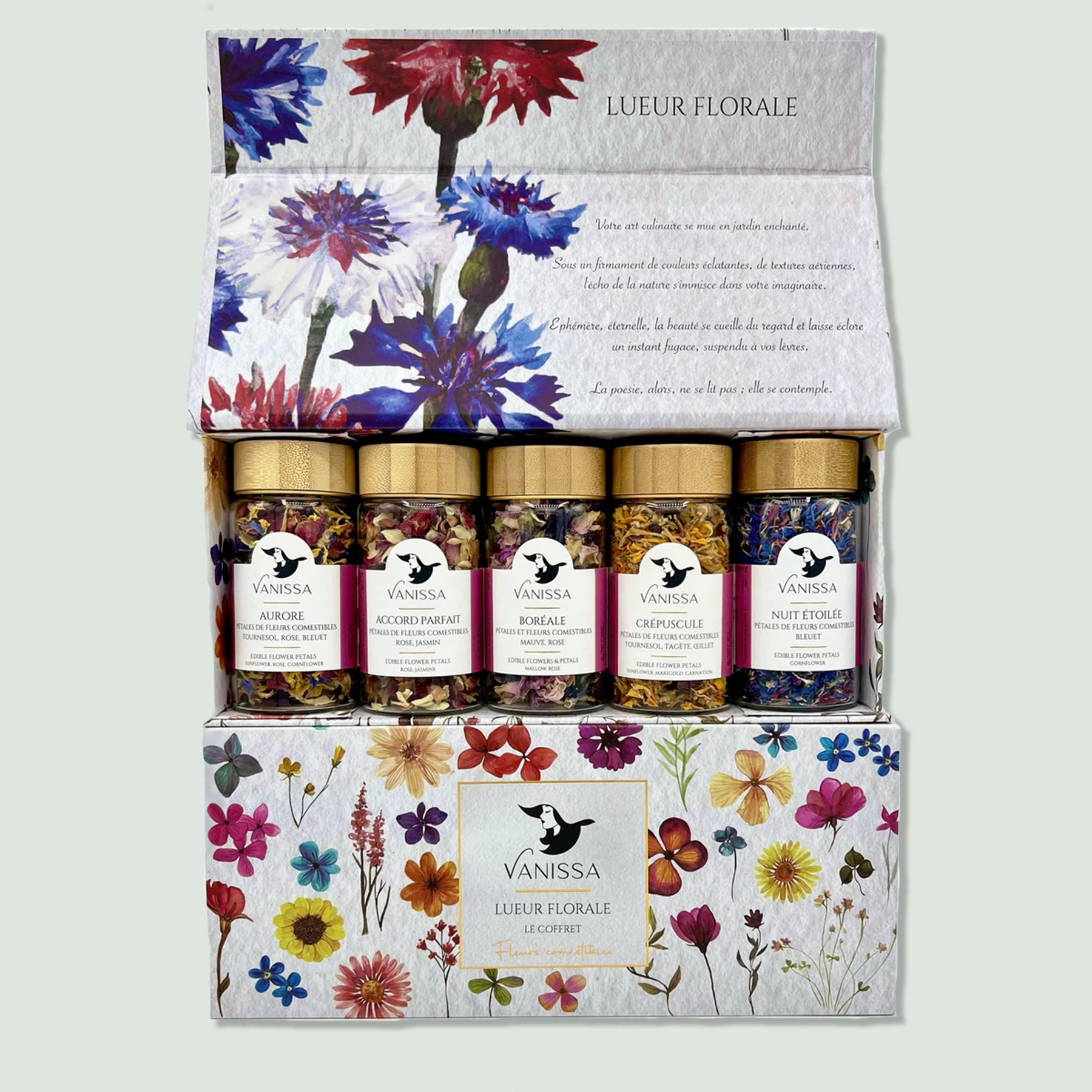 A box labeled "Lueur Florale" containing five jars of mixed herbs by Vanissa. The jars have golden lids and contain colorful blends of edible flowers and herbs. The box features a floral design with various flowers illustrated on it.