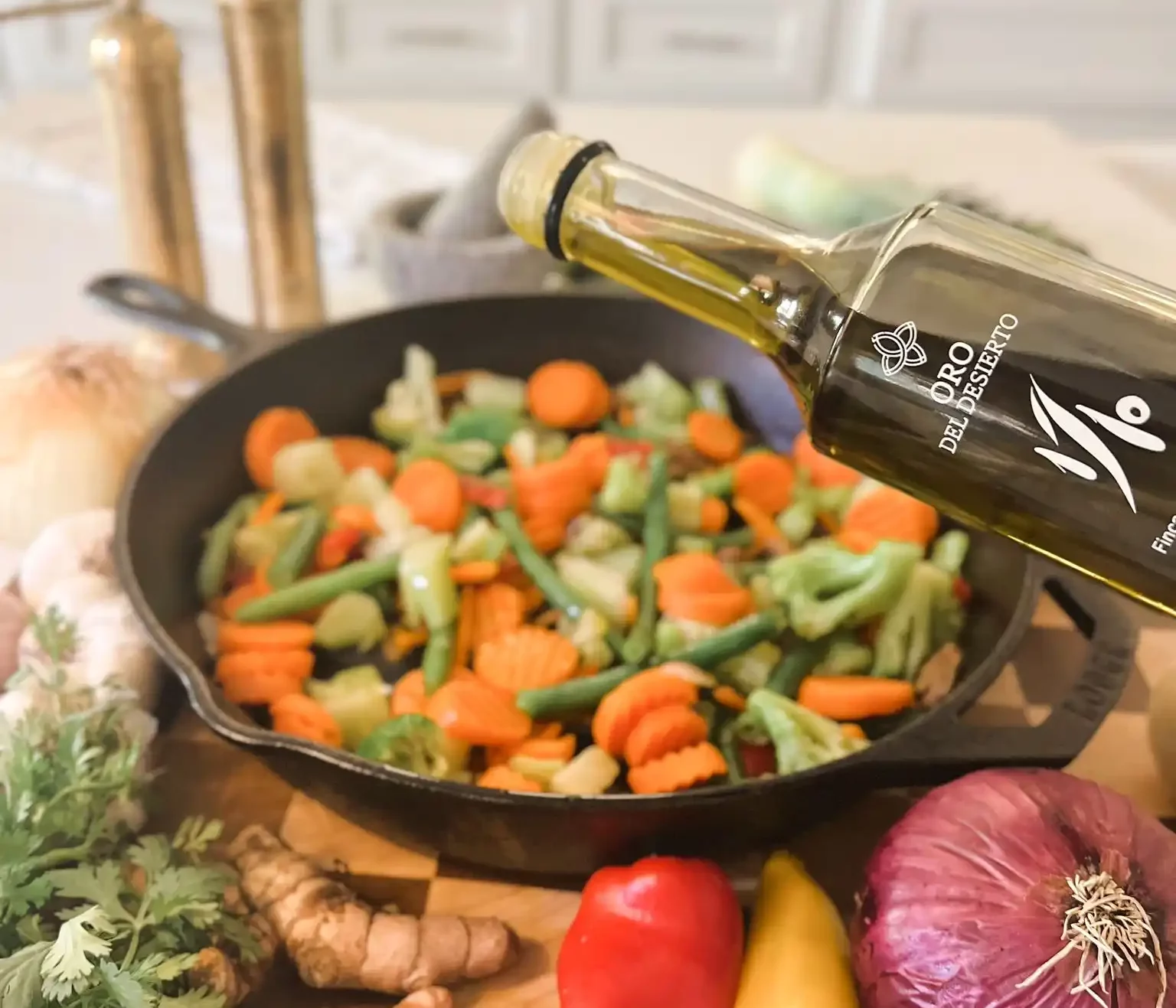 Pouring olive oil into a pan filled with colorful vegetables and herbs.
